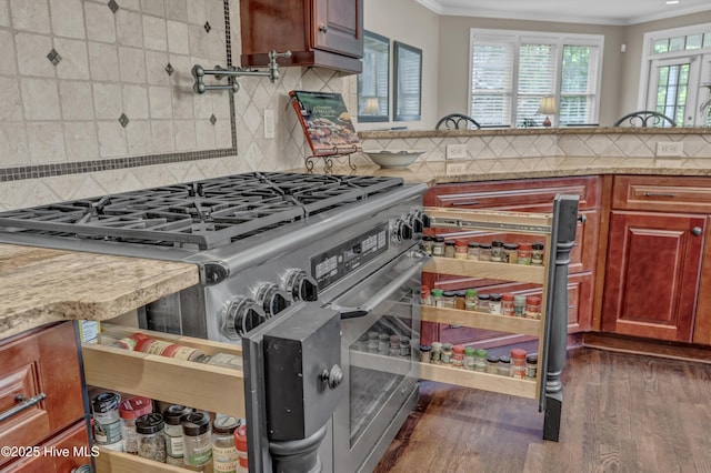 kitchen featuring crown molding, backsplash, dark wood-style floors, and high end range