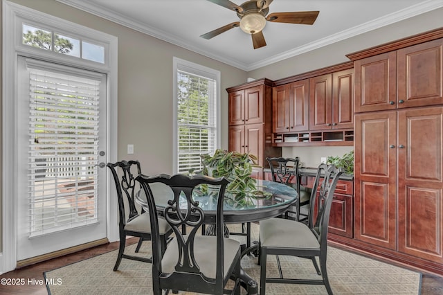 dining room with plenty of natural light, ornamental molding, and a ceiling fan