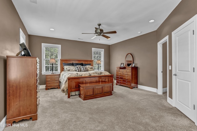bedroom with baseboards, a ceiling fan, and light carpet
