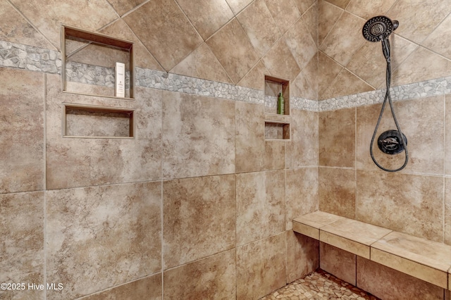 interior details featuring a tile shower