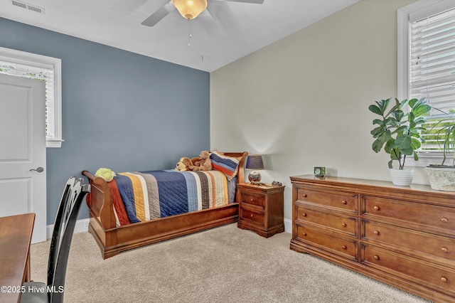 carpeted bedroom with a ceiling fan, baseboards, and visible vents