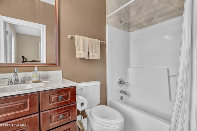 bathroom featuring vanity, shower / bath combination with curtain, and toilet