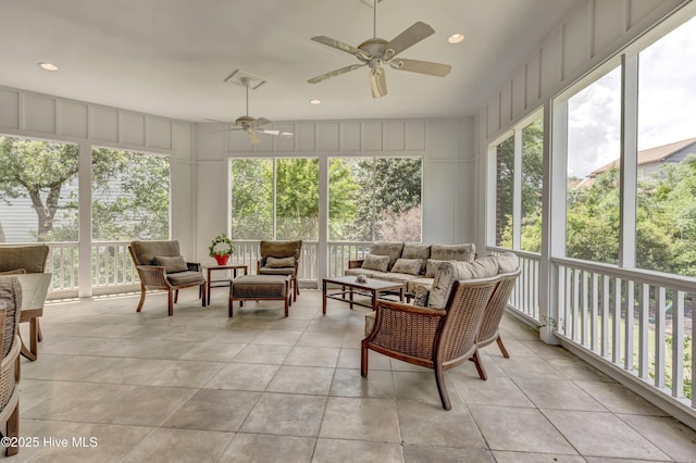sunroom with an outdoor hangout area, ceiling fan, and tile patterned floors