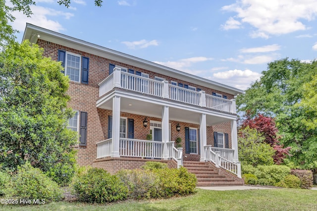 104 River Ct, Wilmington, NC 28412 - view of front of house featuring a balcony, brick siding, and covered porch