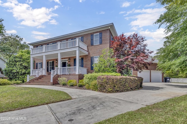 view of front of house with brick siding, a garage, a porch, concrete driveway, and a balcony