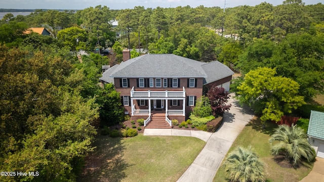 drone / aerial view featuring a wooded view