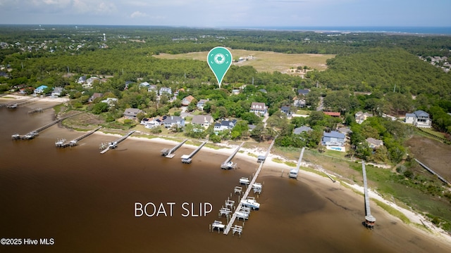 bird's eye view with a water view and a wooded view