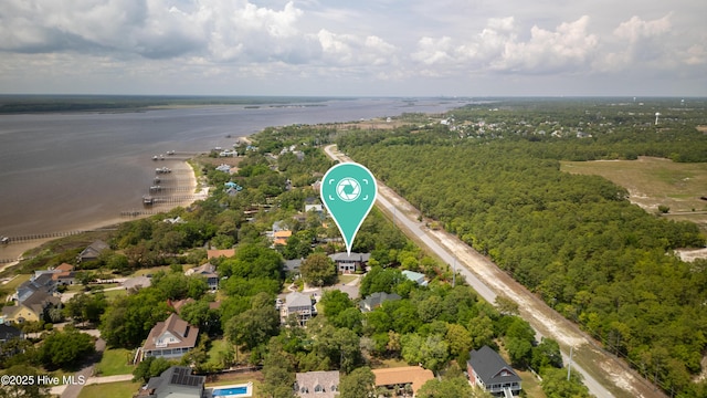birds eye view of property with a water view and a forest view
