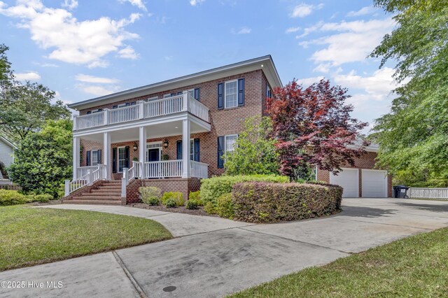 104 River Ct, Wilmington, NC 28412 - view of front of property featuring brick siding, a porch, a garage, driveway, and a balcony
