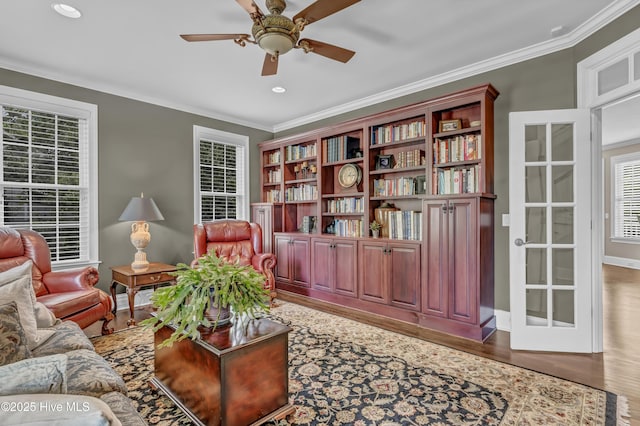 sitting room with crown molding, wood finished floors, baseboards, recessed lighting, and a ceiling fan