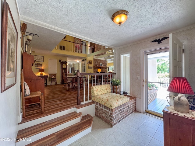522 Hughes Rd, Hampstead, NC 28443 - entrance foyer with a textured ceiling, tile patterned floors, and crown molding