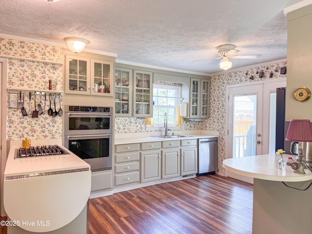 522 Hughes Rd, Hampstead, NC 28443 - kitchen with wallpapered walls, stainless steel appliances, a sink, a textured ceiling, and dark wood-style floors