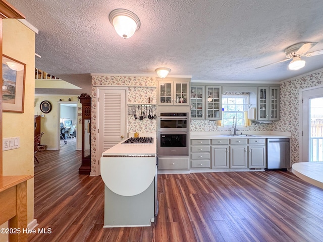 522 Hughes Rd, Hampstead, NC 28443 - kitchen with wallpapered walls, appliances with stainless steel finishes, gray cabinetry, dark wood-type flooring, and a sink