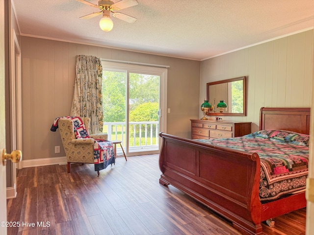 522 Hughes Rd, Hampstead, NC 28443 - bedroom featuring crown molding, access to outside, a textured ceiling, wood finished floors, and wood walls