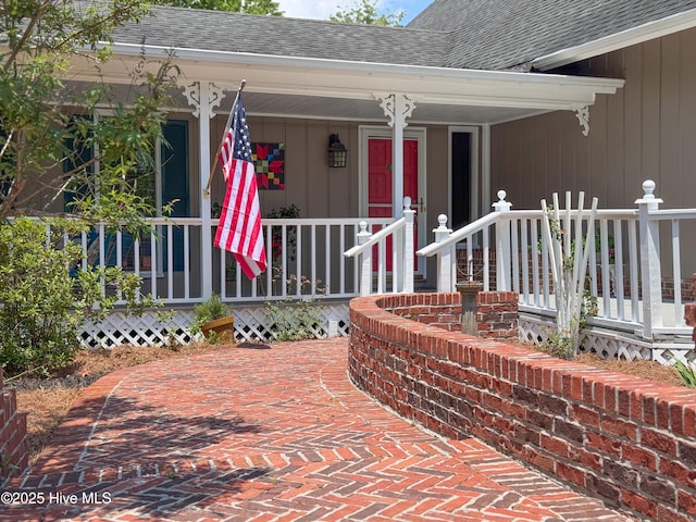 522 Hughes Rd, Hampstead, NC 28443 - view of exterior entry featuring a shingled roof and a porch