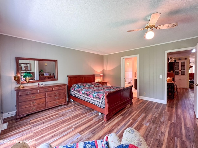 522 Hughes Rd, Hampstead, NC 28443 - bedroom featuring ornamental molding, wood finished floors, a textured ceiling, ensuite bath, and baseboards