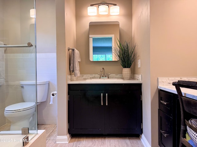 522 Hughes Rd, Hampstead, NC 28443 - bathroom featuring vanity, toilet, and tile walls