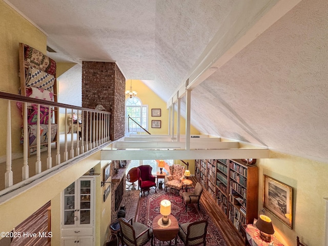 522 Hughes Rd, Hampstead, NC 28443 - stairs featuring a textured ceiling, a chandelier, and high vaulted ceiling