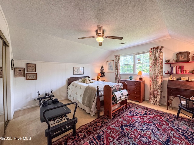 522 Hughes Rd, Hampstead, NC 28443 - bedroom with a textured ceiling, vaulted ceiling, light colored carpet, ceiling fan, and baseboards