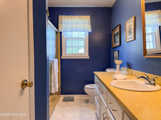 522 Hughes Rd, Hampstead, NC 28443 - bathroom with tile patterned floors, toilet, a shower, vanity, and baseboards