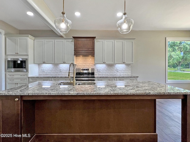 1102 Soundside Rd, Edenton, NC 27932 - kitchen with stainless steel appliances, a sink, tasteful backsplash, decorative light fixtures, and recessed lighting