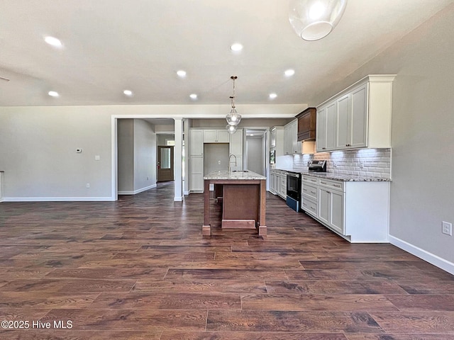 1102 Soundside Rd, Edenton, NC 27932 - kitchen with electric range oven, baseboards, dark wood-style flooring, recessed lighting, and an island with sink