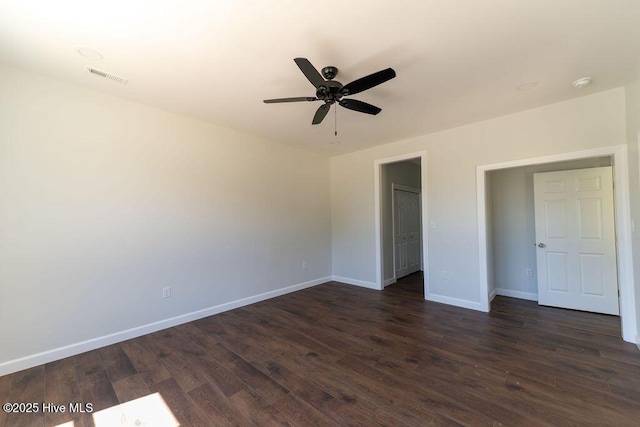 1102 Soundside Rd, Edenton, NC 27932 - unfurnished bedroom featuring baseboards, dark wood finished floors, a ceiling fan, and a closet