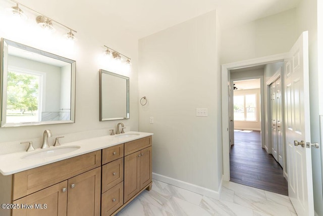 1102 Soundside Rd, Edenton, NC 27932 - bathroom with plenty of natural light, double vanity, baseboards, and marble look tile flooring
