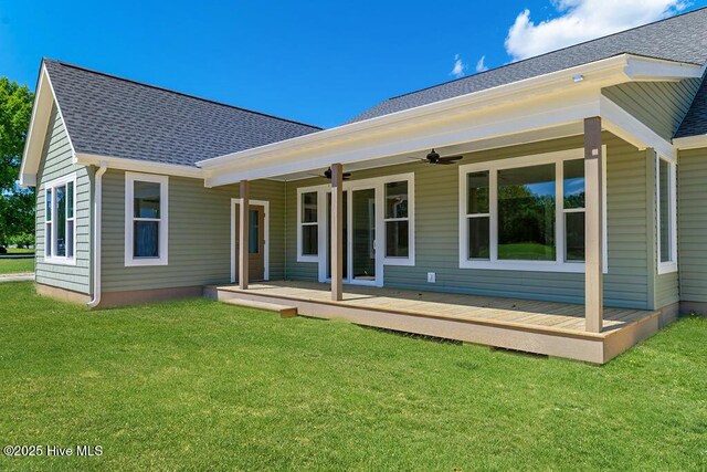 1102 Soundside Rd, Edenton, NC 27932 - rear view of property featuring ceiling fan, roof with shingles, a lawn, and a wooden deck