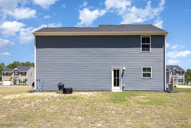 8840 Shallow Creek Trl, Bailey, NC 27807 - back of house featuring a lawn and central AC