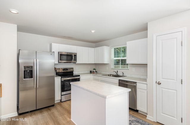 8840 Shallow Creek Trl, Bailey, NC 27807 - kitchen featuring stainless steel appliances, a sink, light wood-style flooring, and a center island