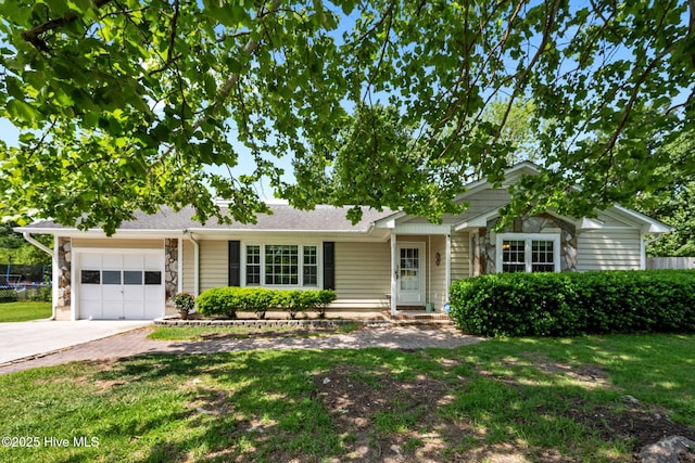 ranch-style house featuring a garage, fence, a front lawn, and driveway