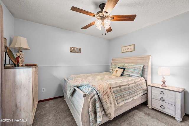 carpeted bedroom featuring a textured ceiling, ceiling fan, and baseboards