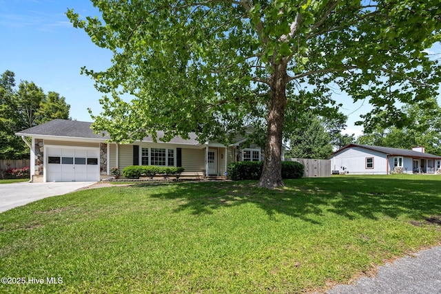 ranch-style house featuring a front lawn, driveway, stone siding, an attached garage, and fence