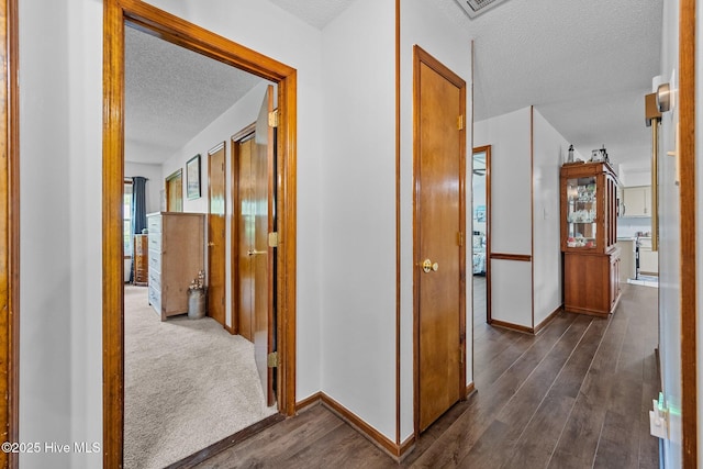 602 Wolverine Pl, Jacksonville, NC 28546 - hallway with a textured ceiling, dark wood finished floors, and baseboards