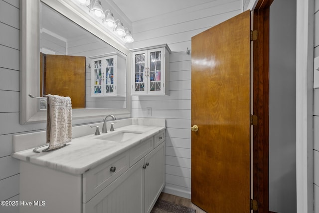 602 Wolverine Pl, Jacksonville, NC 28546 - bathroom with vanity, wood walls, and wood finished floors