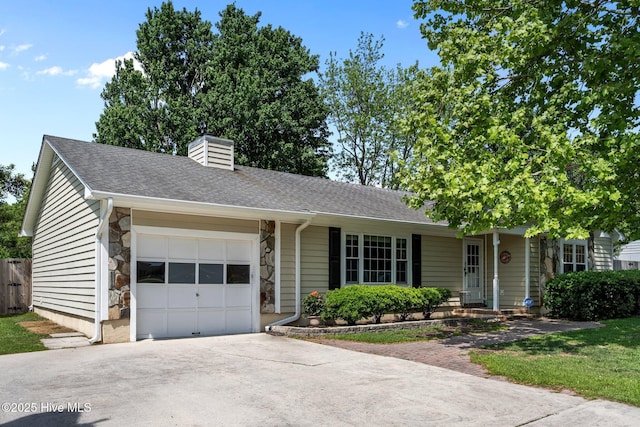 single story home with a chimney, a shingled roof, a garage, driveway, and stone siding