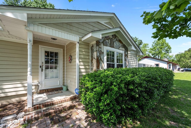 doorway to property with stone siding
