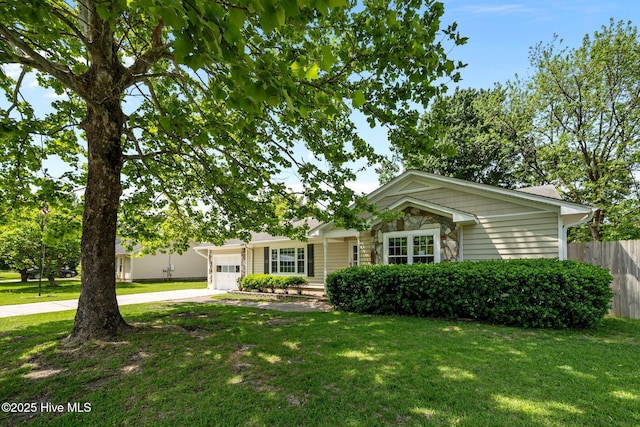 ranch-style home with driveway, fence, a front lawn, and a garage