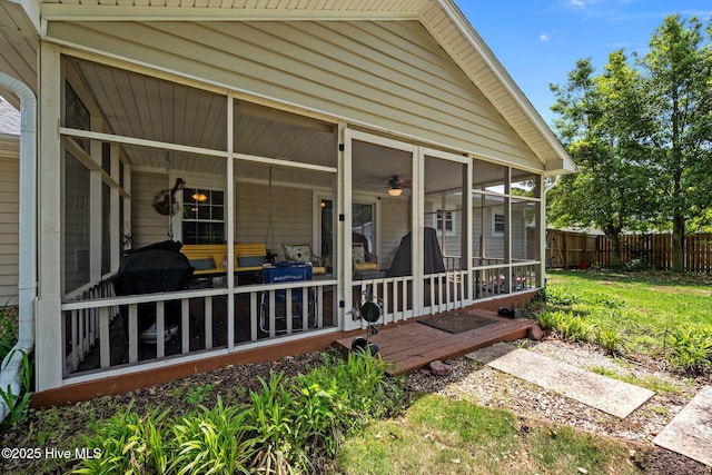 exterior space with fence and a sunroom