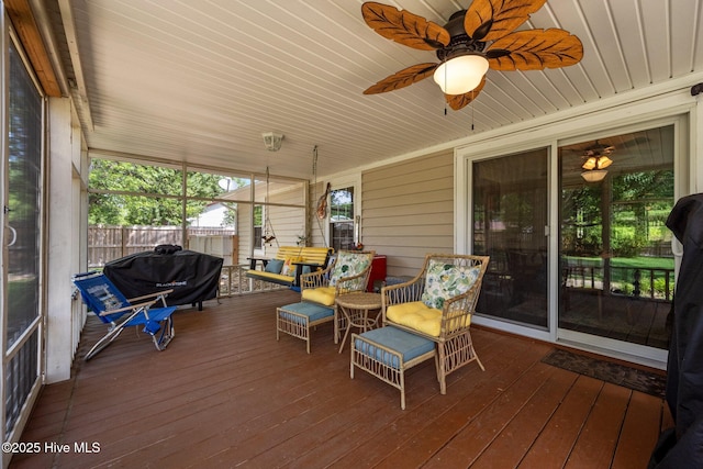 sunroom with a ceiling fan