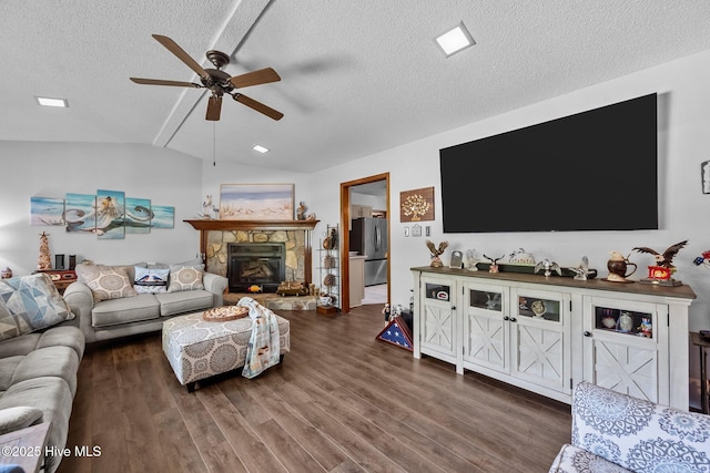 living area with a textured ceiling, ceiling fan, wood finished floors, and lofted ceiling