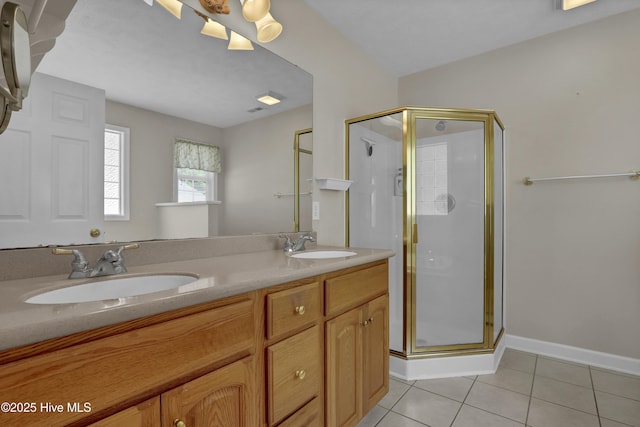 bathroom featuring a sink, tile patterned floors, a shower stall, and double vanity