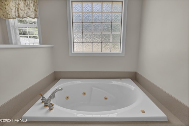 bathroom featuring a tub with jets
