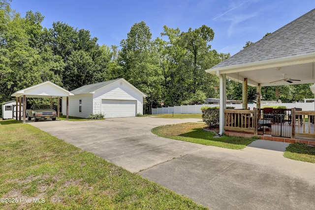 view of property exterior featuring a lawn, a ceiling fan, an outdoor structure, and a detached garage