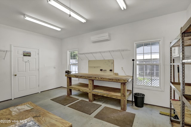 misc room featuring concrete flooring and a wall unit AC