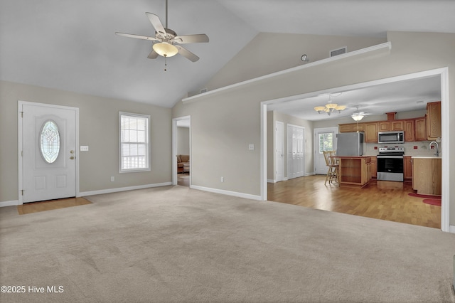 unfurnished living room with ceiling fan, light carpet, high vaulted ceiling, baseboards, and visible vents