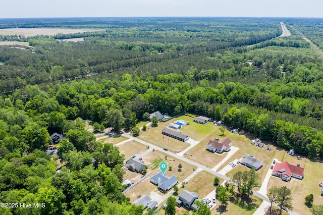 birds eye view of property featuring a forest view
