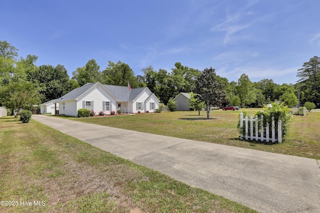 view of front of property with driveway and a front lawn
