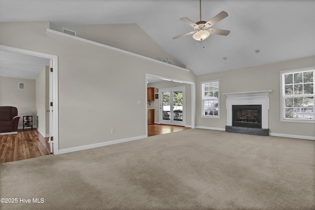 unfurnished living room with visible vents, baseboards, ceiling fan, high vaulted ceiling, and carpet flooring